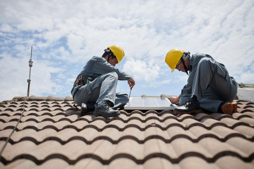 Solar panels being installed on a residential roof in UK